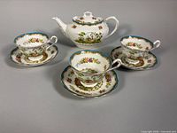 full view of teapot, teacups and saucers showing pattern and quantity