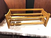 Front view of assembled two-tier wooden shoe rack