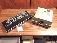 Anscomatic 660 projector beside dbx 900 rack unit on tabletop