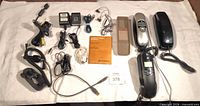 Entire lot laid out showing phones, headset, adapters, cables and manual