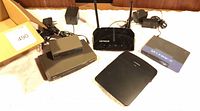 Group shot of all five networking devices with power adapters
