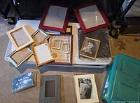 Overall view of assorted frames laid on storage bin and floor