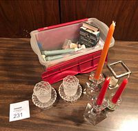 Overall lot with glass candle holders, red crate containing extra candles and wicking box