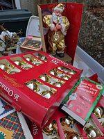Overview showing ornament boxes, Santa figurine, VHS and paper goods in tote