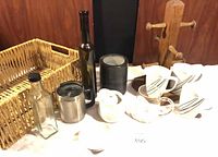 All items grouped showing wicker basket, glass bottles, travel mug, black ceramic container, sugar bowl, mug tree, mugs