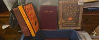 Front view showing Holy Bible, The Best of Christmas in My Heart, two copies of Genghis Khan