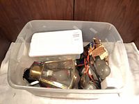 Overall tote with lantern, bulbs, cords, hardware visible