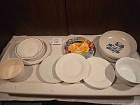 Assorted dinnerware pieces arranged on tray showing full lot