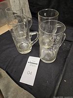 Four etched handled mugs grouped