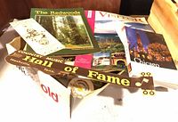 Box of brochures, visitor guides, wooden Country Music Hall of Fame plaque visible