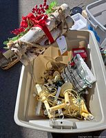 Tote containing birch log bundle, light strings, candle clip lights