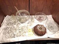 Full lot view: punch bowl with ladle, punch cups, two cake stands, faux cake