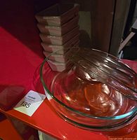 Stacked clear glass mixing bowls and nearby items