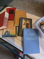 Group of books on table showing several titles and cover conditions
