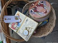 Basket containing multiple decorative tins and glass jar