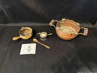 Group shot showing all five items: two spoons, mustard pot, brass ashtray, copper ashtray
