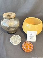 Group shot of vase with grid insert, ceramic planter, clear and amber flower frogs