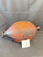 Lidded stoneware baker showing exterior decoration and shape