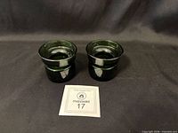 Front view of both green glass candle holders
