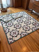 full view of quilt laid on floor with two shams