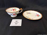 teacup and saucer front view showing pattern and MaxSold label
