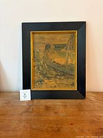 Framed Gauguin print on tabletop showing full view