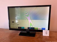 Front view of Samsung TV powered on displaying smart menu