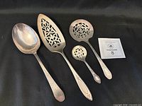 all four Community Plate serving utensils side by side