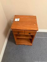 Front top view of birch nightstand showing drawer, shelf and overall form