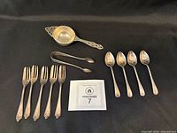 Group shot of all sterling pieces on black background