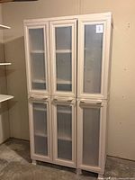 Front view of closed beige plastic cabinet