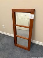 Full view of 3-pane window mirror leaning against wall