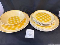 Full set arranged showing bowl nested in platter and stack of plates