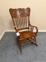 Full view of wooden pressed back rocking chair
