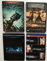 Front covers of four DVDs: The Dark Knight, Gangs of New York, Unbreakable, Die Hard 2