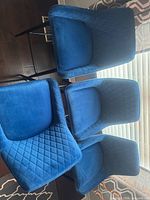 Three navy blue upholstered bar stools showing overall style and color