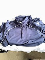 Navy blue Sport-T golf shirt laid flat showing front, collar and piping detail