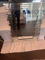 Front view of mirror showing stacked mirrored glass frame and reflective surface