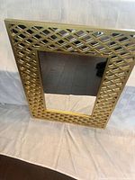 Front view showing gold lattice frame and mirror panel
