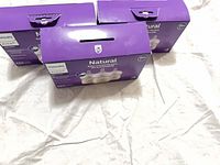 Three of the retail boxes tops visible