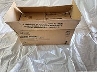 Open shipping carton showing multiple Leolight tealight candle boxes