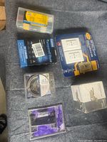 All six packaged items on grey surface