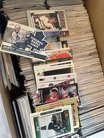 Top layer of box showing assorted NHL cards including Matt Sundin card and Calgary Flames themed card