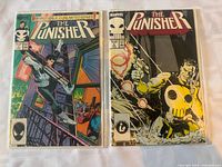 Front covers of The Punisher #1 and #2 ongoing series in sleeves