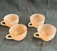 Four pink Dogwood pattern cups grouped
