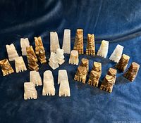 All 33 marble chess pieces arranged on blue background