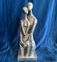 Full view of silver abstract couple sculpture on base