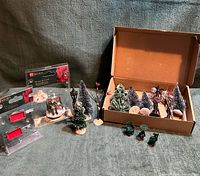 group shot of all accessories including boxed trees, patio set, lamp post, bare tree, blister-pack items