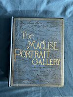 Front cover showing blue cloth boards with gilt title and facsimile signatures