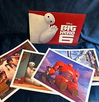 All four lithographs spread out with folder